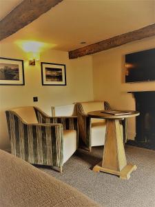 a living room with a couch and a chair at Queens Head Inn & Restaurant in Hawkshead