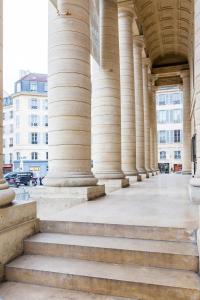 a row of columns on a building with stairs at Veeve - Latin Quarter Retreat in Paris