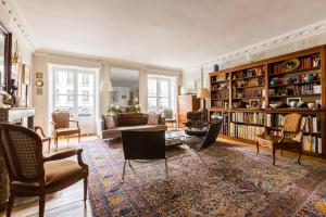a living room with a lot of bookshelves at Veeve - Latin Quarter Retreat in Paris