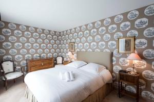 a bedroom with a bed and a wall covered in plates at Veeve - Steps from the Eiffel Tower in Paris