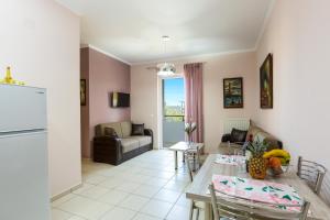 a kitchen and living room with a table and chairs at Cozy Guest House in Rethymno
