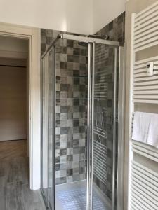 a shower with a glass door in a bathroom at A casa di Chiara in Stresa