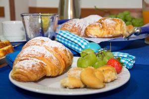 two plates of pastries and fruit on a blue table at A Pastaiola in Cetara