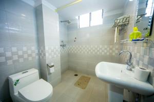 a bathroom with a white toilet and a sink at Thamel Home in Kathmandu