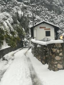 a snow covered road next to a building at Residence Mezzosole in Riva del Garda