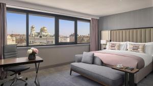 a hotel room with a bed and a desk and a window at InterContinental Sofia by IHG in Sofia