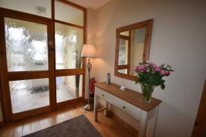a bathroom with a large window and a large mirror at Aaranmore Lodge Guest House in Portrush