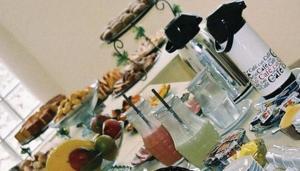 a table with a bunch of food and drinks at Hotel Portal de Barequeçaba in Barequeçaba