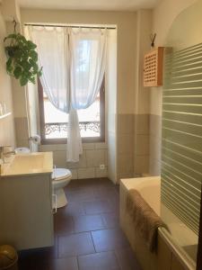 a bathroom with a tub and a toilet and a window at Chaillac Bed & Breakfast in Chaillac