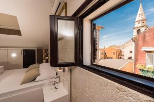a room with a window with a view of a church at Apartments Donat in Zadar