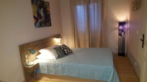 a bedroom with a bed with two pillows on it at Appartement Cemiliana in Bonifacio