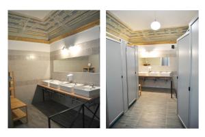 ein Badezimmer mit 2 Waschbecken und ein Badezimmer mit einem Spiegel in der Unterkunft Balarm Hostel - Youth Hostel age limit 18-50 in Palermo