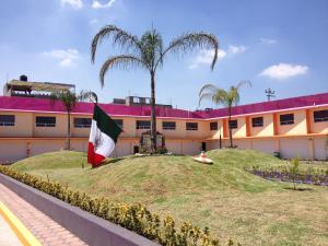 a building with a flag in front of it at Hotel & Villas 7 in Mexico City