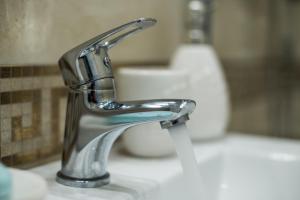 a bathroom sink with a chrome bathroom faucet at Middle of The Boulevard in Alba Iulia