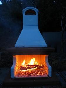 a fire pit with a pot on top of it at Casa di Ester - villino con vista panoramica e giardino privato sulla collina di Porto Stefano - Monte Argentario - Vikey in Porto Santo Stefano