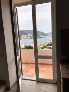 a door to a balcony with a view of the ocean at Casa GARY in Ponza