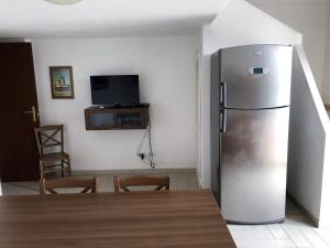 a kitchen with a refrigerator and a table and chairs at Casa GARY in Ponza