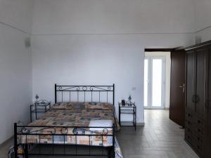 a bedroom with a bed in a white room at Casa GARY in Ponza