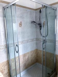 a shower with a glass shower stall in a bathroom at Casa GARY in Ponza +10 photos