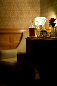 a table with a lamp and a chair in a room at Wentworth Mansion in Charleston