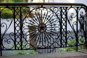 a wrought iron fence with a flower on it at Wentworth Mansion in Charleston