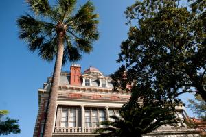 a palm tree in front of a building at Wentworth Mansion in Charleston
