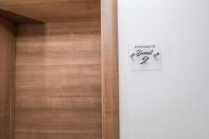 a door with a sign that reads assemblies bond at Apartments Donat in Zadar