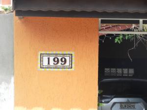 a sign on the side of a building at ACIOLY'S BEACH HOUSE in Caraguatatuba