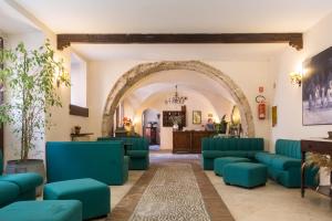 a living room filled with lots of furniture at Hotel Alle Vecchie Arcate in Pescasseroli