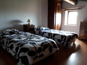 a bedroom with two beds and a window at La Grange in Cruis