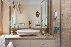 a bathroom with a sink and a shower at Valdibora Sea View Residence in Rovinj +16 photos