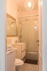 a bathroom with a shower and a toilet and a sink at Premium Studio by MRG Apartments in Bucharest +16 photos