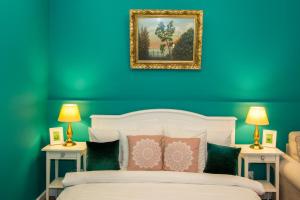 a blue bedroom with a white bed with two night stands at Premium Studio by MRG Apartments in Bucharest