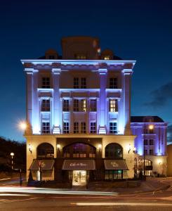 a building lit up in blue at night at Killarney Plaza Hotel & Spa in Killarney