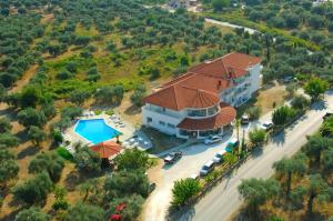 an aerial view of a house with a swimming pool at Achillion Hotel in Skala Potamias