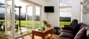 a living room with a couch and a table at Stoneleigh Village in Sidmouth