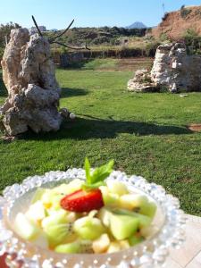 a plate of fruit with a strawberry on it at Arodamos Studios Apartments in Kissamos