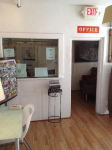 an office with a table and a chair in a room at Miami Springs Inn in Miami