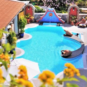 a large swimming pool with a slide and a playground at Arciduca Grand Hotel in Lipari