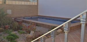 a swimming pool on the side of a building at Casa Pedro in Roquetas de Mar