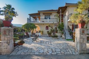 a house with a stone patio in front of it at Olive Tree Apartment in Lagópodhon