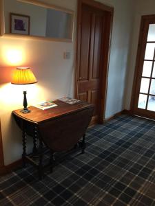 a lamp sitting on a table in a room at Brackenbrae Holiday Cottage in Acharacle