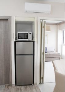 eine Küche mit einer Mikrowelle auf dem Kühlschrank in der Unterkunft Waterfront Luxury Sea View Apartment in Thessaloniki