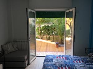 a bedroom with a door open to a patio at Albamare in Monterosso al Mare