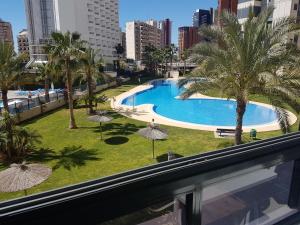 a view of a swimming pool from the balcony of a building at GEMELOS 26 APARTMENTS - Benidormland in Benidorm
