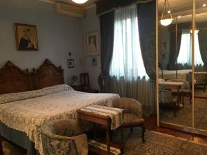 1 dormitorio con cama y espejo en B&B Les Fleurettes, en Lomazzo