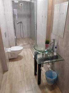 a bathroom with a toilet, sink, and tub at Kaktus Guest House in Katowice