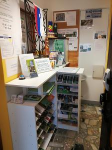 a room with a desk with a book shelf at Hacienda Bled Rooms in Bled