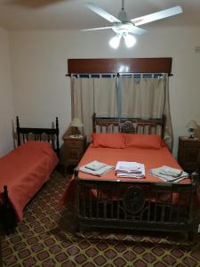 a bedroom with two beds and a ceiling fan at Los Nogales de Yerua in Calabacillas