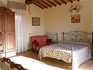 a bedroom with a bed and a chair at Agriturismo Le Rose in Pescia Romana +64 photos